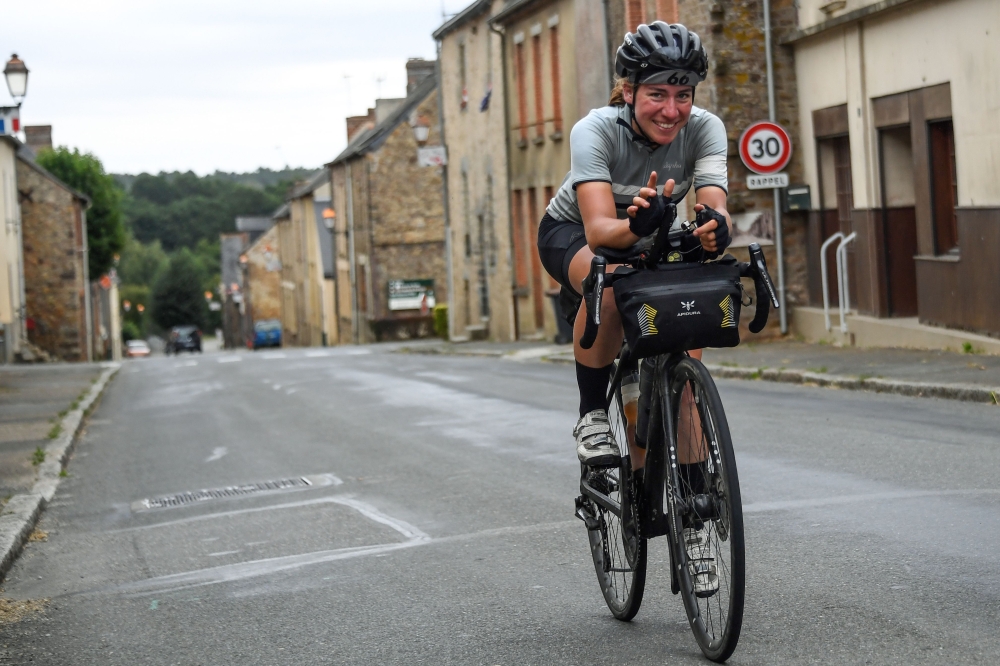 German cancer researcher from Heidelberg Fiona Kolbinger, 24, rides her bicycle on August 5, 2019 near the village of Teillay, Brittany, on her way to be the first woman to win the 2,500 miles ultra-endurance cycling Transcontinental Race from Bulgaria to
