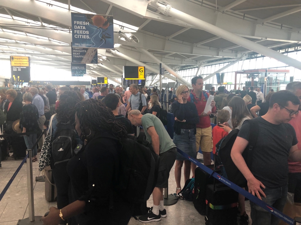Passengers wait in long queues at Heathrow Airport as IT problems caused flight delays in London, Britain, August 7, 2019 in this picture obtained from social media. Paul Trickett 