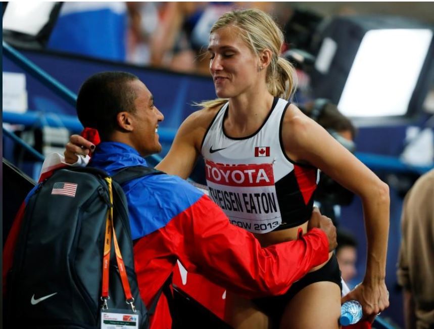 Brianne Theisen Eaton of Canada is embraced by her husband decathlon Olympic and world champion Ashton Eaton of the US after the women's heptathlon 800 metres heat event of the IAAF World Athletics Championships at the Luzhniki Stadium in Moscow, Russia, 