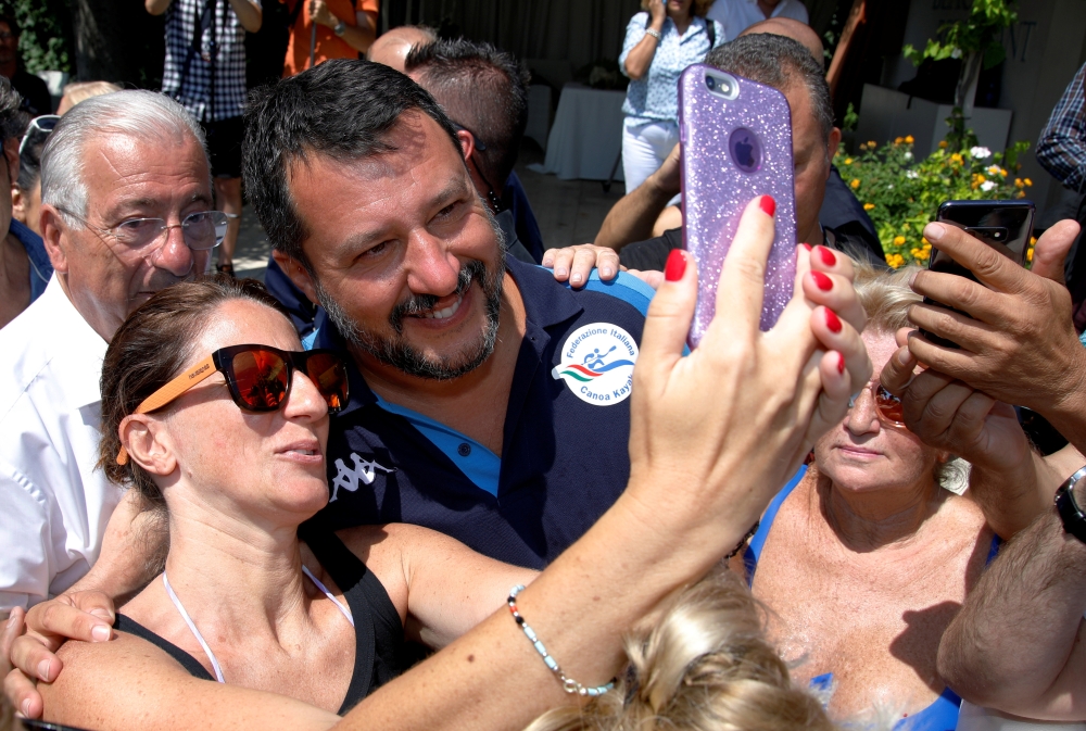 Italian Interior Minister and leader of the League party Matteo Salvini poses for a selfie as he meets supporters at the Caparena beach in the Sicilian seaside town of Taormina, Italy, August 11, 2019. (REUTERS/Antonio Parrinello)