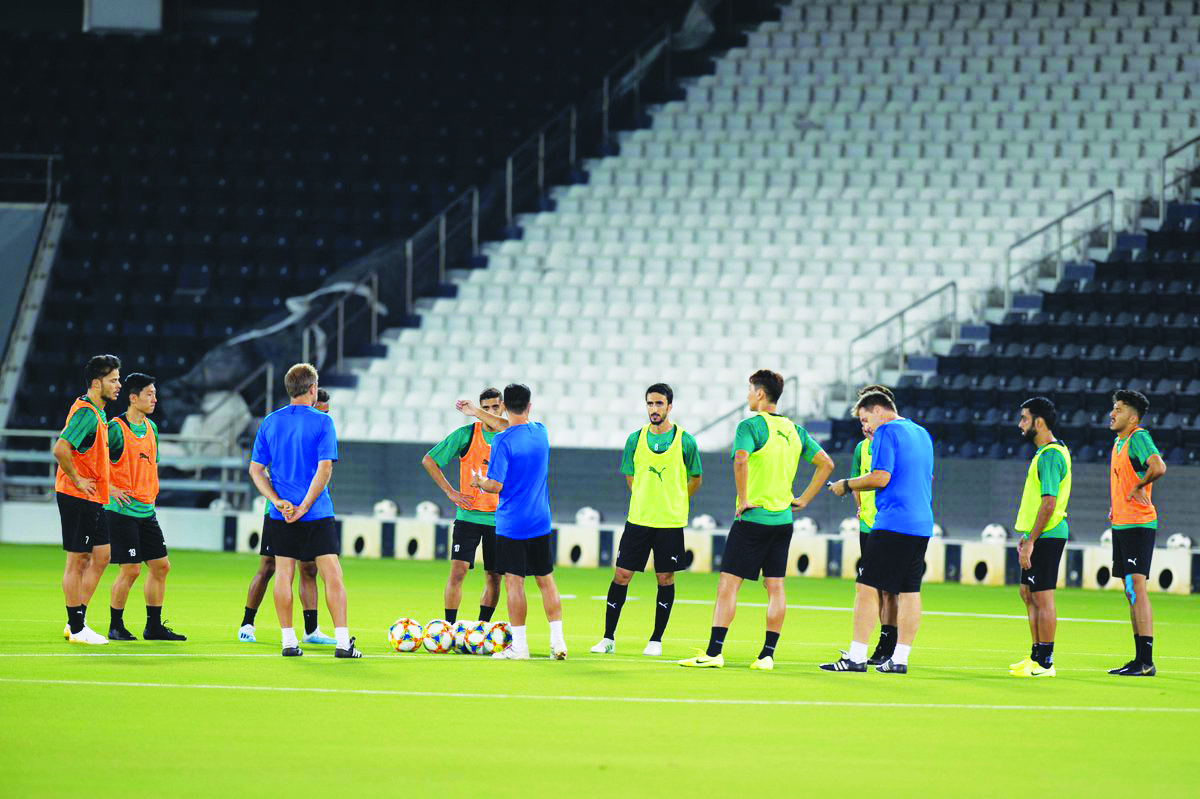 Coach Xavi Hernandez (centre) giving instructions to Al Sadd players during a training session in Doha, yesterday, as they prepare for tomorrow’s AFC Champions League Round of 16 second leg match against Al Duhail.