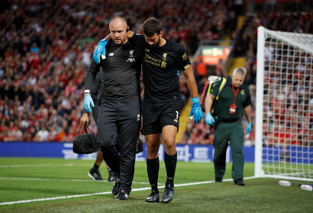 Liverpool's Alisson is helped off the pitch as he is substituted after sustaining an injury (REUTERS/Phil Noble)