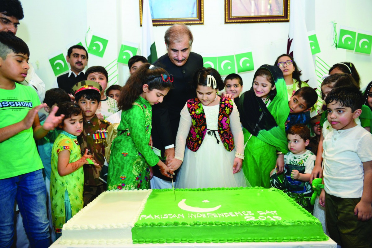 The Ambassador cutting a cake with children as part of the celebrations.