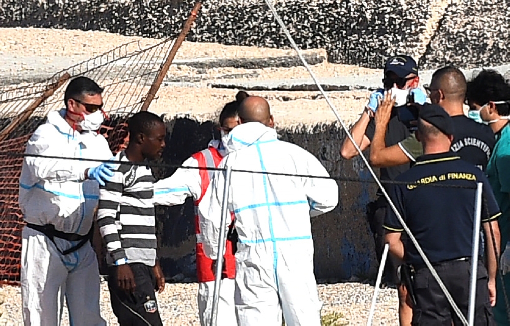 A minor who was among migrants stranded on the Spanish migrant rescue ship Open Arms disembarks in Lampedusa, Italy August 17, 2019. (REUTERS/Guglielmo Mangiapane)