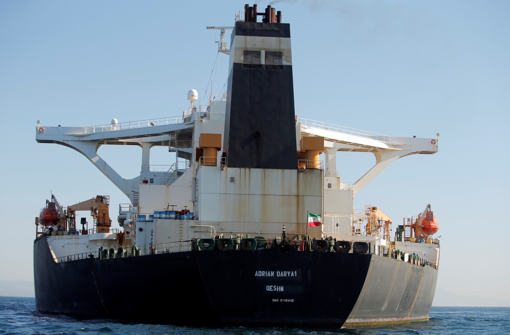 An Iranian flag flies at Iranian oil tanker Adrian Darya 1, before being named as Grace 1, as it sits anchored after the Supreme Court of the British territory lifted its detention order, in the Strait of Gibraltar, Spain, August 18, 2019. REUTERS/Jon Naz