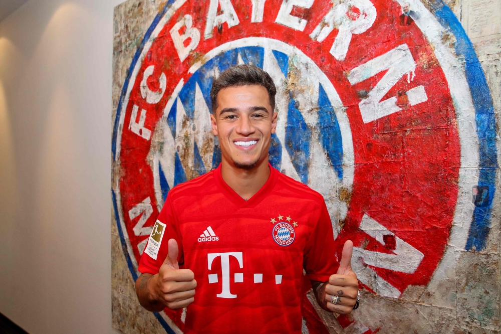 Brazilian midfielder Philippe Coutinho, new recruit of German first division Bundesliga football club FC Bayern Munich, poses in front of Bayern Munich's logo at the club's grounds in Munich, southern Germany, on August 18, 2019.