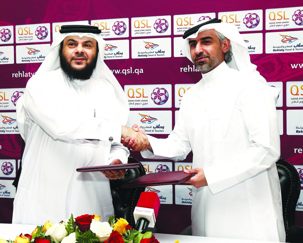 Yousuf Al Awadhi, Vice-Chairman of Rehlaty Travel & Tourism company exchanging sponsorship documents with Al Kuwari, Executive Director of Marketing, Sales and Communication at QSL.