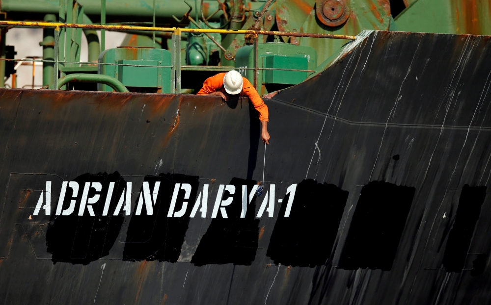 A crew member takes pictures with a mobile phone on Iranian oil tanker Adrian Darya 1, previously named Grace 1, as it sits anchored after the Supreme Court of the British territory lifted its detention order, in the Strait of Gibraltar, Spain, August 18,