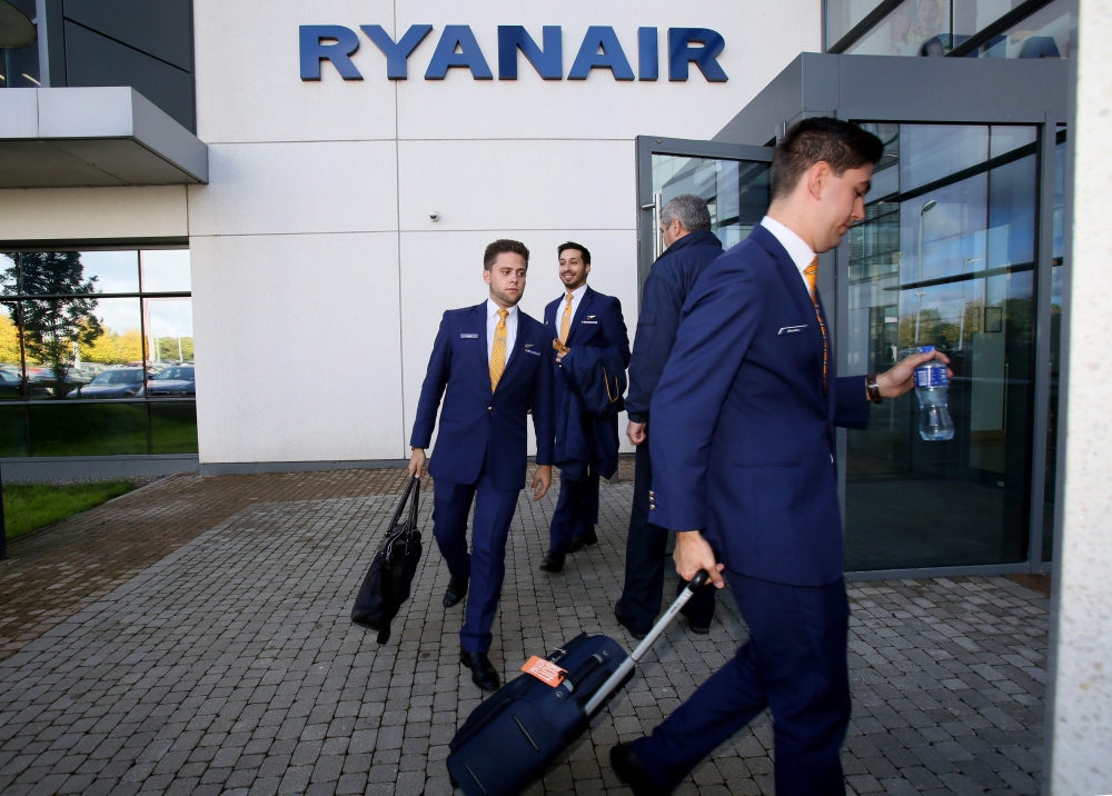 (FILES) In this file photo taken on September 21, 2017 Staff leave Ryanair headquarters at Airside Business Park in Dublin on September 21, 2017. AFP / Paul Faith 
