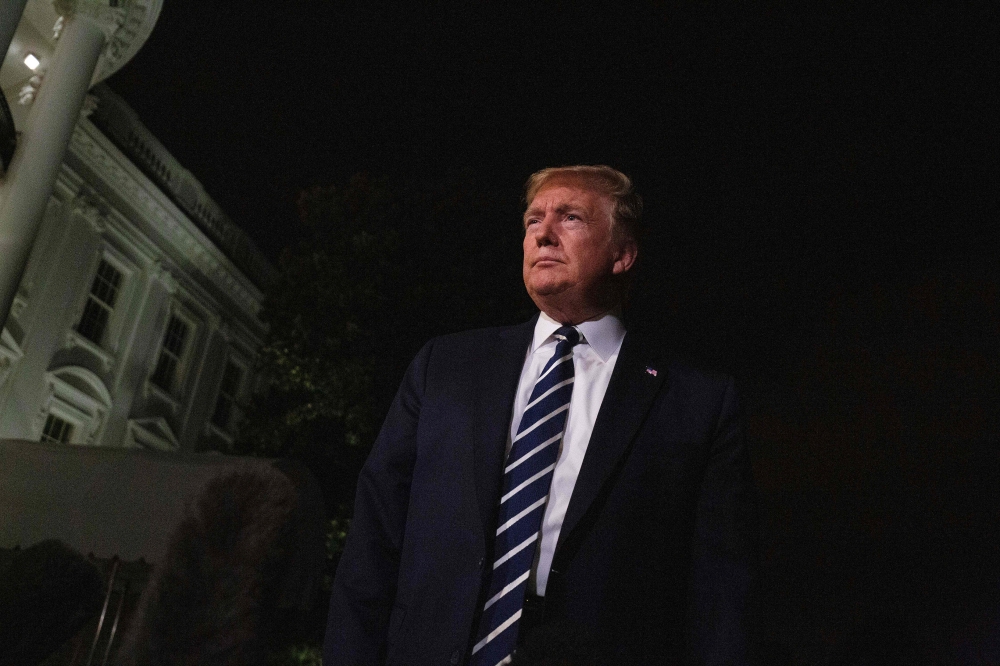 US President Donald Trump speaks to the press as he departs the White House in Washington, DC, on August 23, 2019, for the G7 Summit in France. / AFP / Alastair Pike