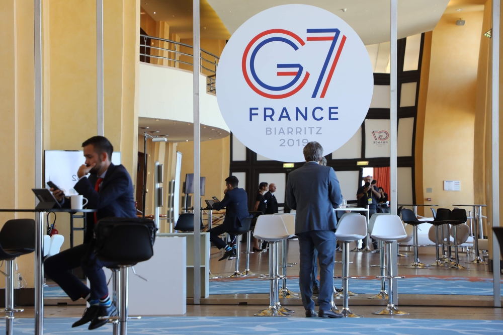 People work the advanced press centre in the Casino of Biarritz, south-west France on August 24, 2019, on the first day of the annual G7 Summit attended by the leaders of the world's seven richest democracies, Britain, Canada, France, Germany, Italy, Japa