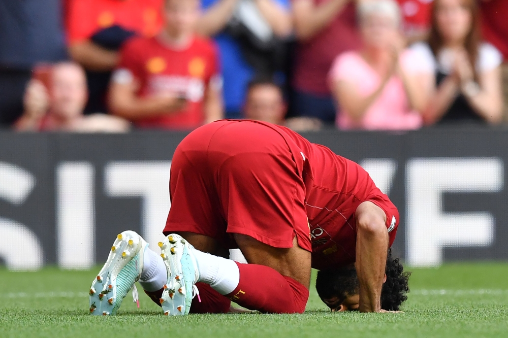 Liverpool's Egyptian midfielder Mohamed Salah celebrates after scoring their second goal from the penalty spot during the English Premier League football match between Liverpool and Arsenal at Anfield in Liverpool, north west England on August 24, 2019. A