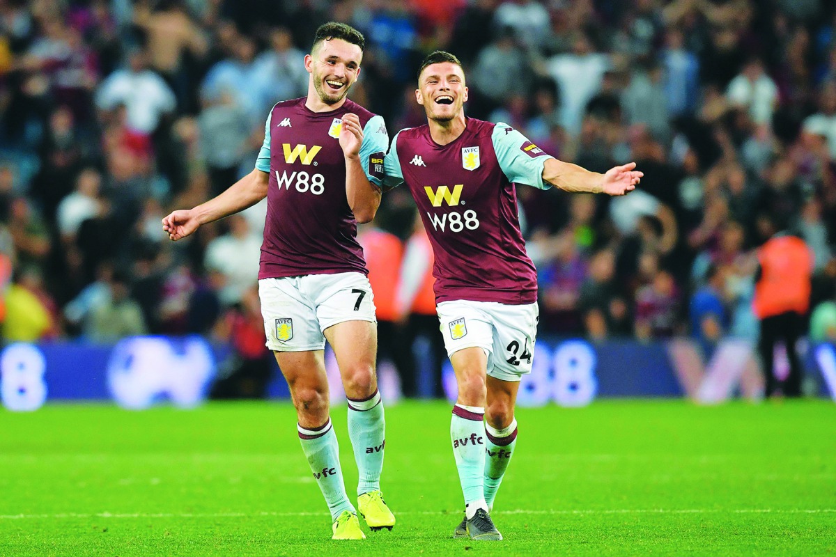 Aston Villa Scottish midfielder John McGinn and French defender Frederic Guilbert celebrate at the end of the English Premier League football match between Aston Villa and Everton at Villa Park in Birmingham, central England on August 23, 2019. AFP / Ben 