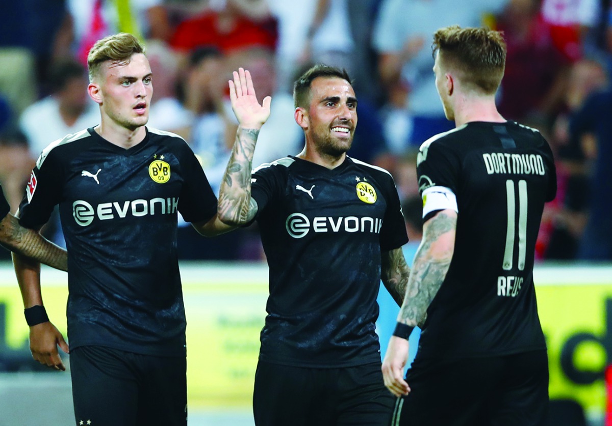 Borussia Dortmund's Paco Alcacer celebrates scoring their third goal with team mates. Reuters/Wolfgang Rattay