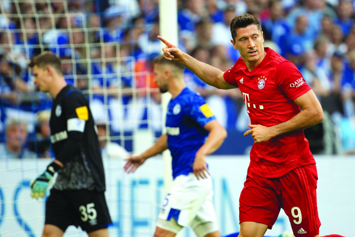 Bayern Munich's Polish forward Robert Lewandowski celebrates scoring the opening goal from the penalty spot during the German first division Bundesliga football match FC Schalke 04 FC Bayern Munich in Gelsenkirchen, western Germany on August 24, 2019. AFP
