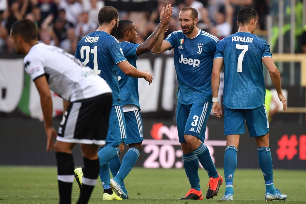 Juventus' Italian defender Giorgio Chiellini (2ndR) celebrates after opening the scoring during the Italian Serie A football match Parma vs Juventus on August 24, 2019 at the Ennio-Tardini stadium in Parma. / AFP / Marco Bertorello