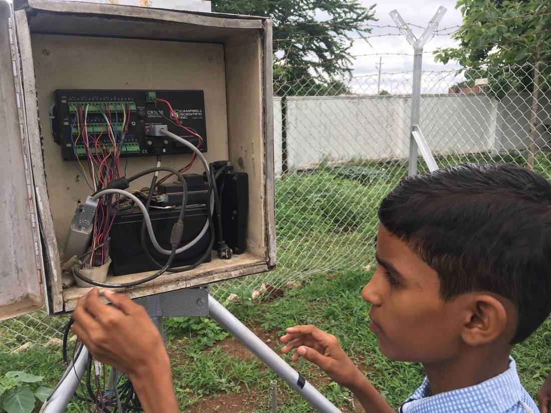 Ninth grader Vamshi Voggu at the automatic weather station on the school premises in Kothapally, India, on July 31, 2019. Thomson Reuters Foundation/Roli Srivastava