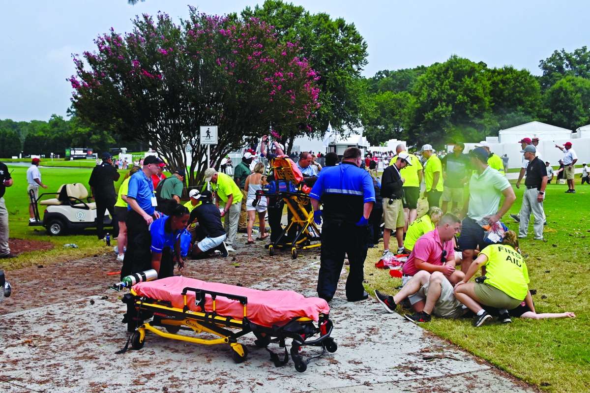 Fans are assisted by medical personnel after a lightning strike during the third round of the Tour Championship golf tournament at East Lake Golf Club.Credit: Adam Hagy-USA TODAY Sports 