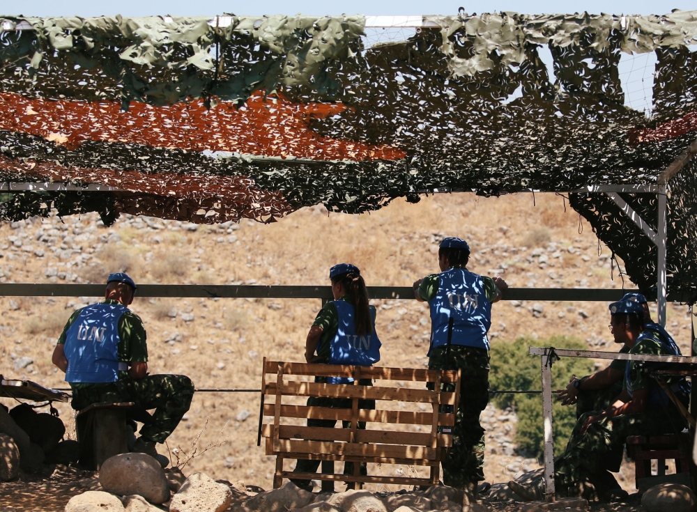 U.N peacekeepers of the United Nations Interim Force in Lebanon (UNIFIL) sit together in al-Wazzani area in southern Lebanon, Lebanon August 26, 2019. REUTERS/Ali Hashisho