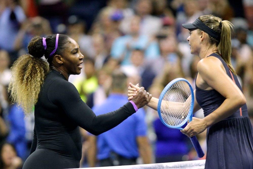 Maria Sharapova (R) of Russia shake hands after losing against Serena Williams of the United Sates during their Round 1 women's Singles match at the 2019 US Open at the USTA Billie Jean King National Tennis Center in New York on August 26, 2019. / AFP / K