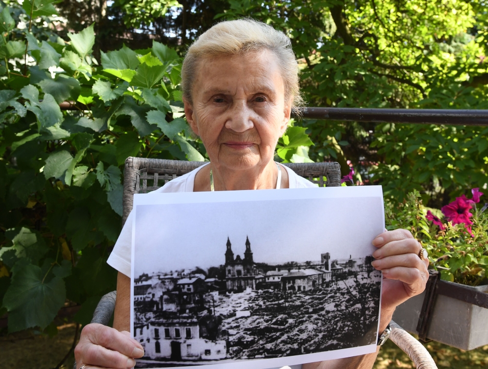 Zofia Burchacinska, an eyewitness to the bombing of Wielun holds a picture of the destroyed town on August 20, 2019. AFP / Janek Skarzynski