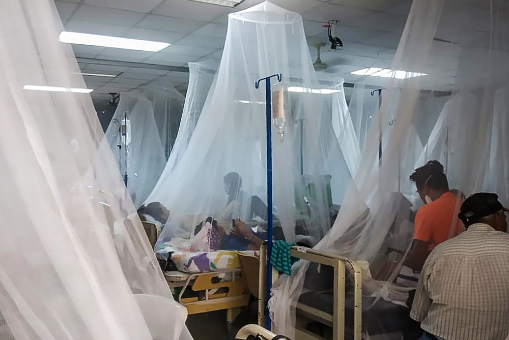 Relatives remain with patients infected with dengue fever in the San Juan de Dios Hospital in Esteli, Nicaragua, on August 25, 2019.  AFP /