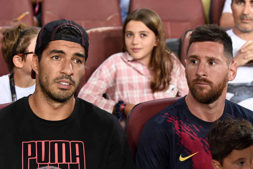 Barcelona's Uruguayan forward Luis Suarez (L) and Barcelona's Argentine forward Lionel Messi sit in the tribune during the Spanish League football match between Barcelona and Real Betis at the Camp Nou stadium in Barcelona on August 25, 2019. / AFP / Jose