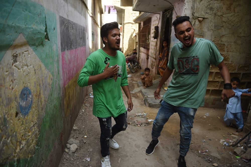 Rappers Mohammad Omar (R) and Wasim Masih perform in Lyari, one of Pakistan’s most dangerous neighbourhoods, in Karachi, on May 19, 2019. AFP / Rizwan Tabassum