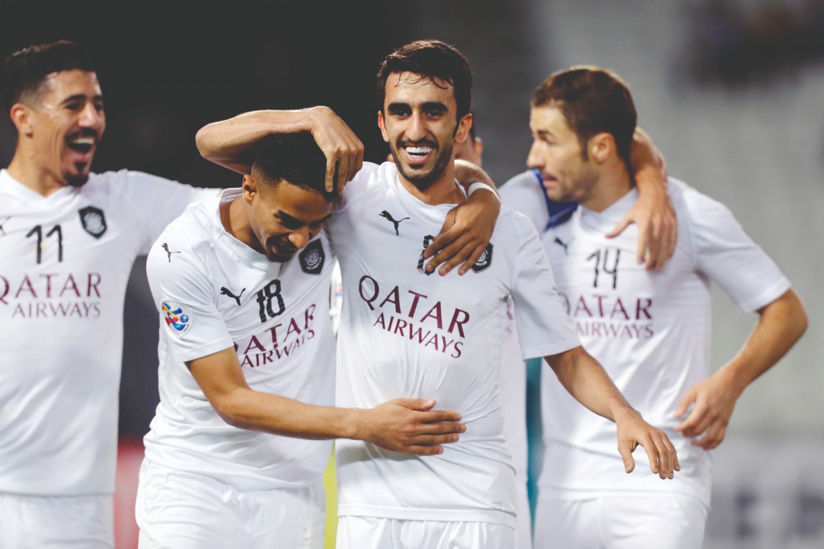 Al Sadd’s Al Asad (centre) celebrates with team-mates after scoring their opening goal against Saudi Arabia’s Al Ahli during the AFC Champions League Group D match played in Doha.