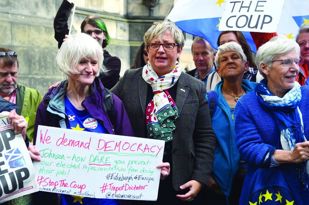 Joanna Cherry (C), Scottish National Party (SNP) MP poses with anti-Brexit protestors outside the Court Of Session in Edinburgh, Scotland on August 30, 2019. AFP / Andy Buchanan