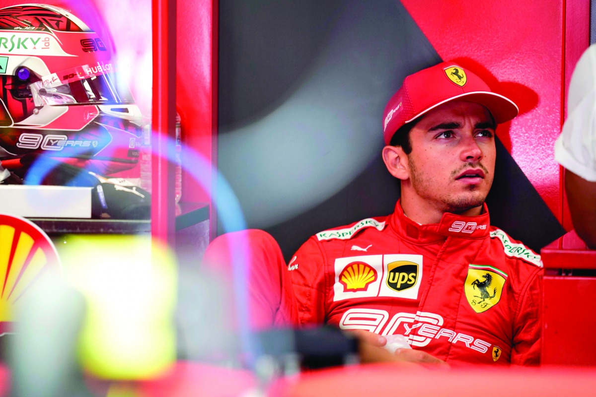 Ferrari's Monegasque driver Charles Leclerc looks on in the pits during the second practice session at the Spa-Francorchamps circuit in Spa on August 30, 2019 ahead of the Belgian Formula One Grand Prix. AFP / Kenzo Tribouillard
