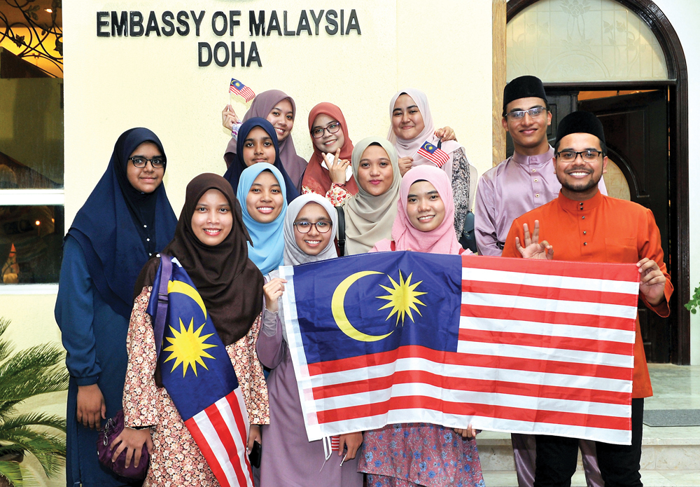 Malaysian students at various universities in Qatar holding their national flag during a function to celebrate the National Day of Malaysia at the Embassy of Malaysia in Doha, on Friday. 
Pics: Salim Matramkot / The Peninsula
