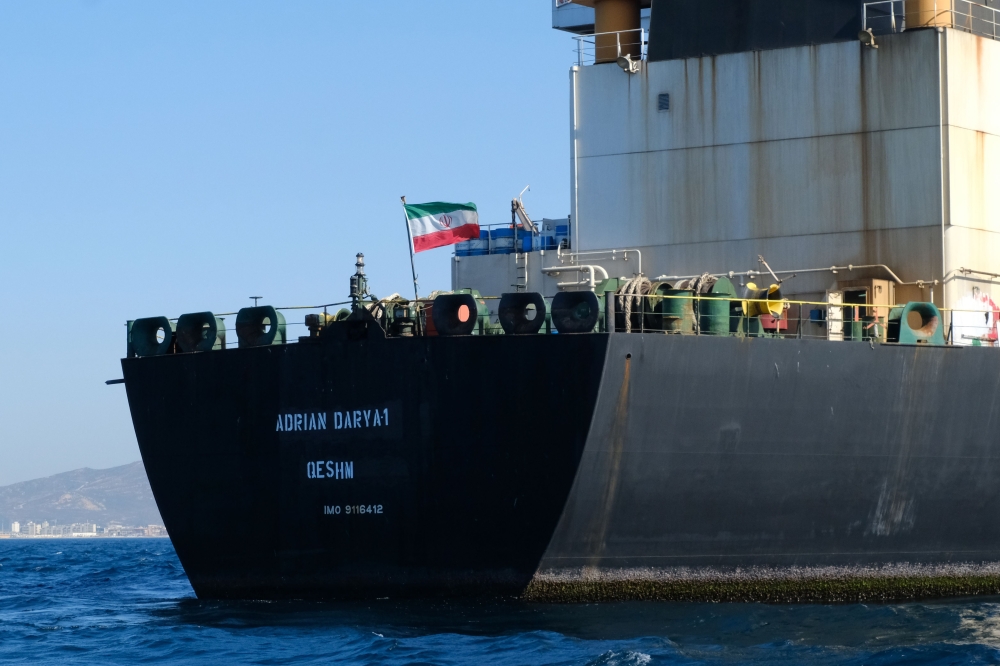 FILE PHOTO:  An Iranian flag flutters on board the Adrian Darya oil tanker, formerly known as Grace 1, off the coast of Gibraltar. AFP / Johnny BUGEJA