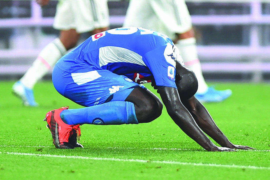 Napoli's Kalidou Koulibaly looks dejected after scoring an own goal and Juventus' fourth.  Reuters/Massimo Pinca 