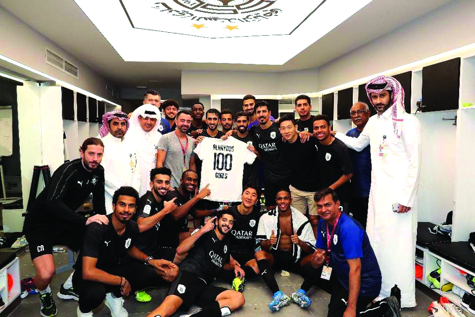 Al Sadd players and officials celebrate Hassan Al Haydos 100 goal milestone for Al Sadd.