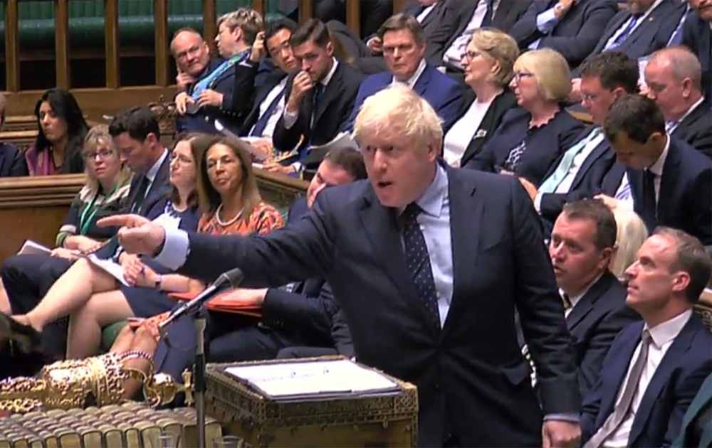 A video grab from footage broadcast by the UK Parliament's Parliamentary Recording Unit shows Prime Minister Boris Johnson gestures toward the opposition benches on September 3, 2019. 