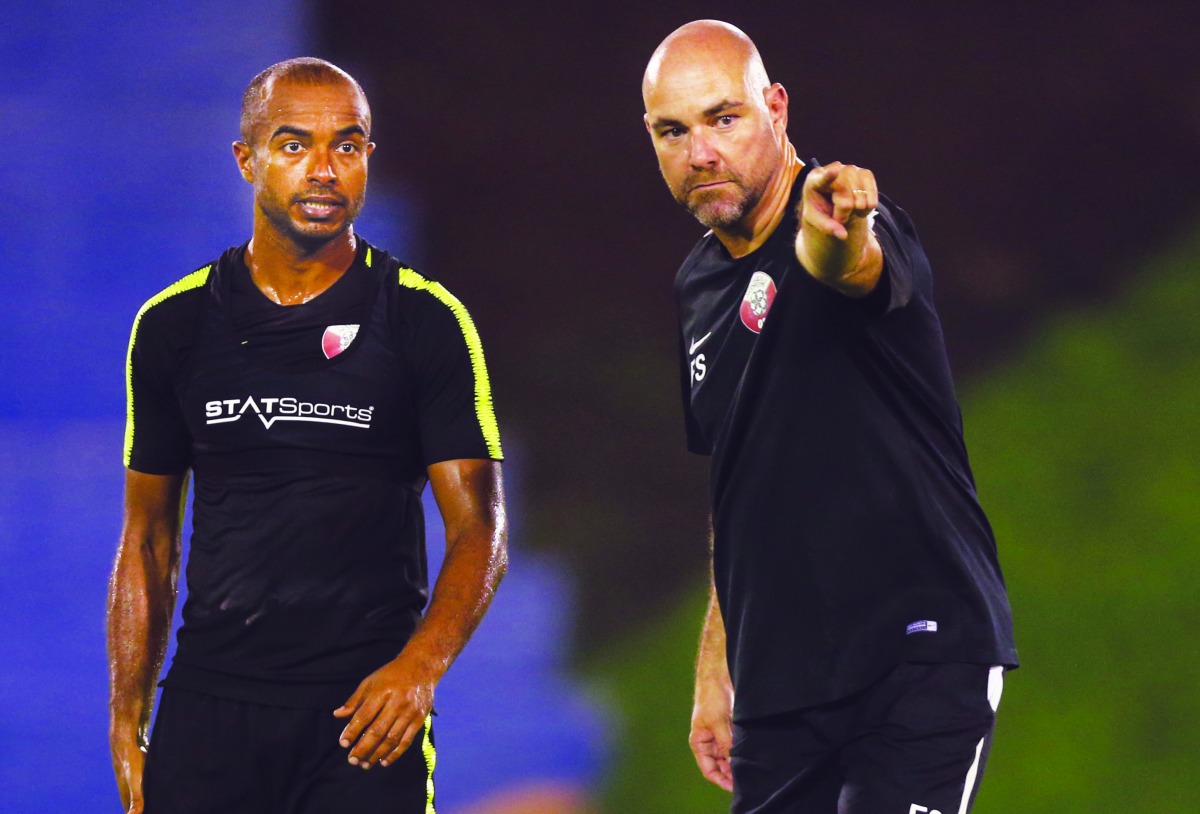 Qatar head coach Felix Sanchez (right) giving instructions to striker Ali Afif during the session. 