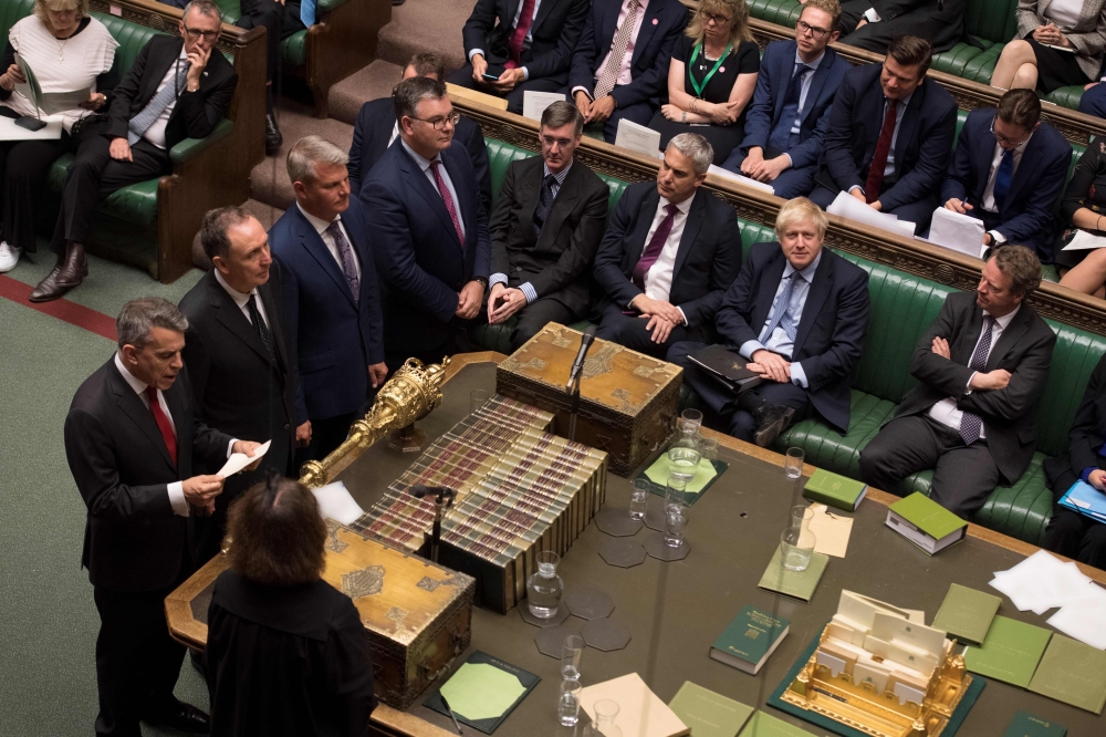 A handout photograph released by the UK Parliament shows Britain's Prime Minister Boris Johnson (CR) listening as the tellers read out the result of the vote on the EU (Withdrawal) (No.6) Bill in the House of Commons in London on September 4, 2019. AFP PH