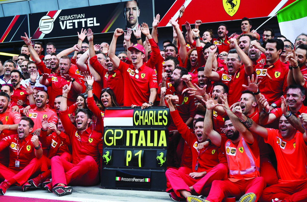 Ferrari's Charles Leclerc celebrates winning the race with team mates. Reuters/Massimo Pinca 