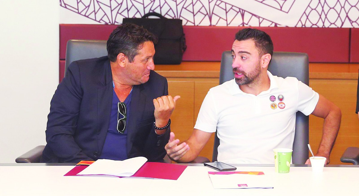 Al Sadd’s Spanish coach, Xavi Hernandez (right) speaks with an official during the co-ordination meeting hosted by Qatar Stars League at the Al Bidda Tower, in Doha, yesterday.