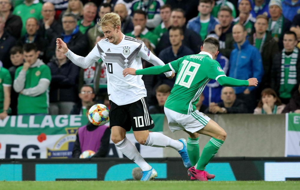 Germany's midfielder Julian Brandt (L) takes on Northern Ireland's midfielder Gavin Whyte (R) during the the Euro 2020 football qualification match between Northern Ireland and Germany at Windsor Park in Belfast on September 9, 2019. / AFP / Paul Faith