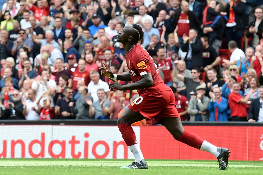 Liverpool's Senegalese striker Sadio Mane celebrates after he scores the team's second goal during the English Premier League football match between Liverpool and Newcastle at Anfield in Liverpool, north west England on September 14, 2019.  AFP / Paul ELL