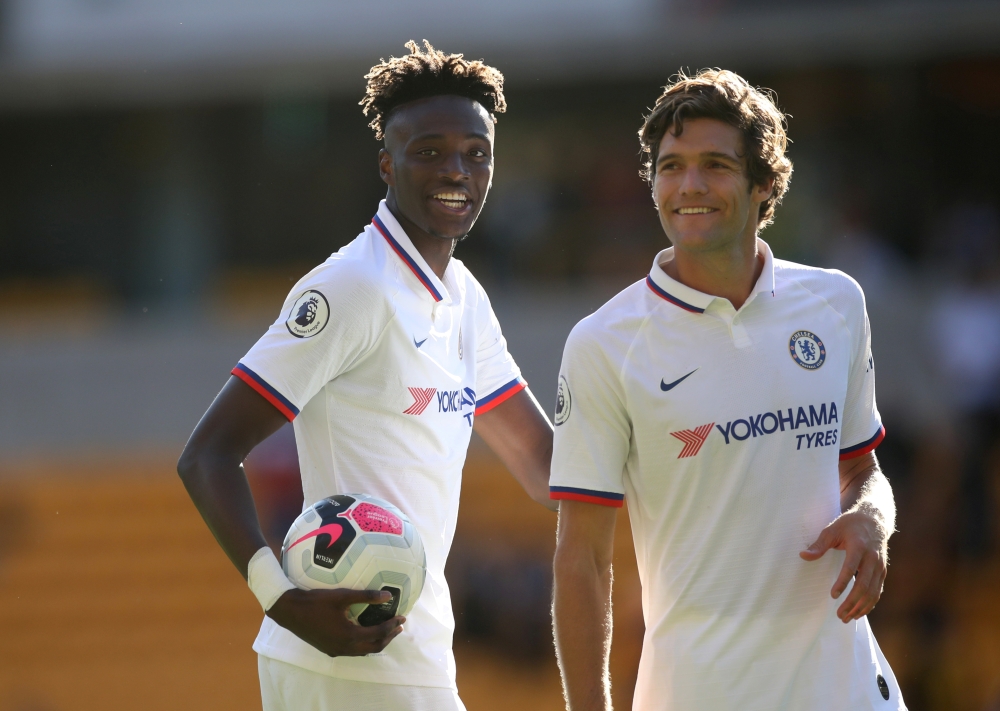 Chelsea's Tammy Abraham celebrates with teammate Marcos Alonso whilst holding the matchball after scoring a hat-trick. Reuters/Carl Recine 