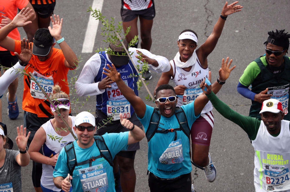 Activist and treegrower Siyabulela Sokomani celebrates as he approaches the final stretch of the Cape Town marathon, in South Africa September 15, 2019. REUTERS/Mike Hutchings