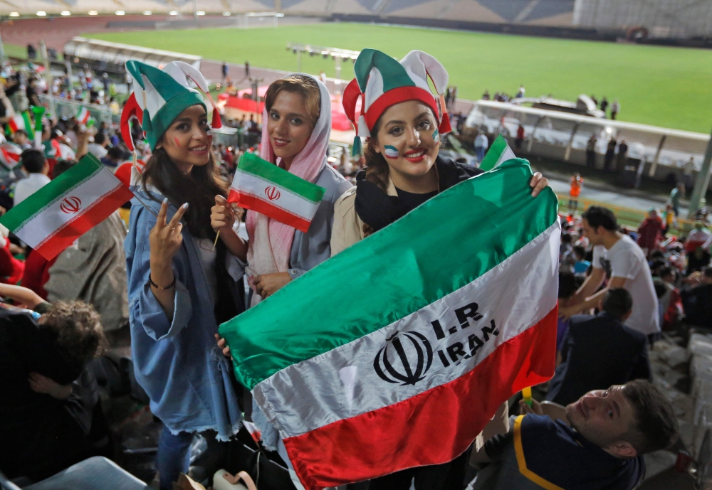 FILE PHOTO: Iranian women watch the World Cup Group B soccer match between Portugal and Iran at Azadi stadium in Tehran. AFP / ATTA KENARE
