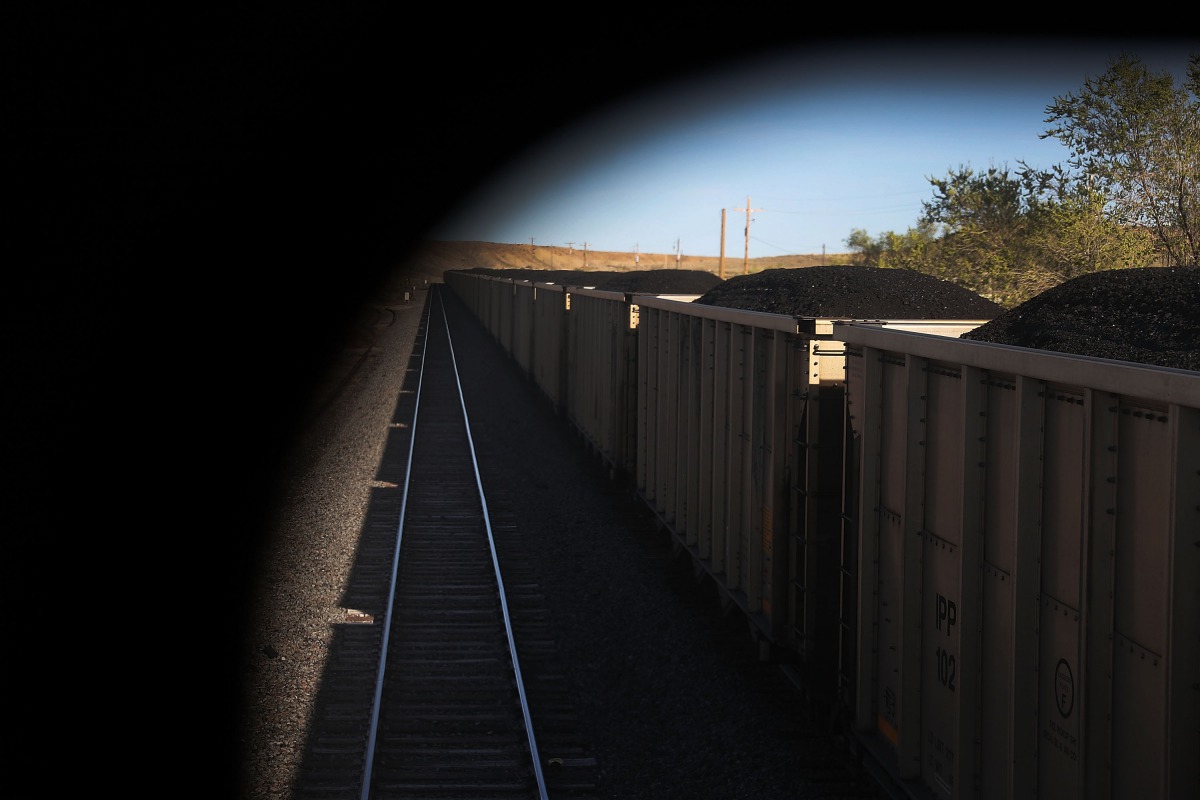 Train cars loaded with coal pass California Zephyr as it rolls along the tracks during its daily 2438-mile trip to Emeryville, San Francisco from Chicago. Joe Raedle / Getty Images / AFP
