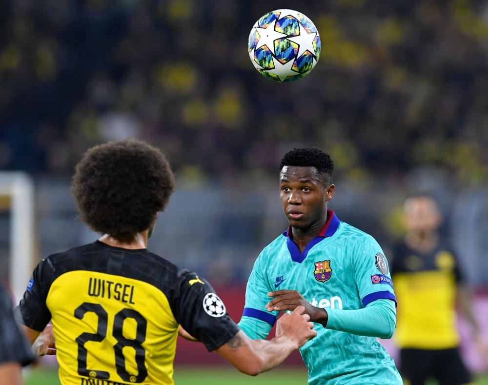 Barcelona´s Guinea-Bissau forward Ansu Fati (R) and Dortmund's Belgian midfielder Axel Witsel (L) vie for the ball during the UEFA Champions League Group F football match Borussia Dortmund v FC Barcelona in Dortmund, western Germany, on September 17, 2019
