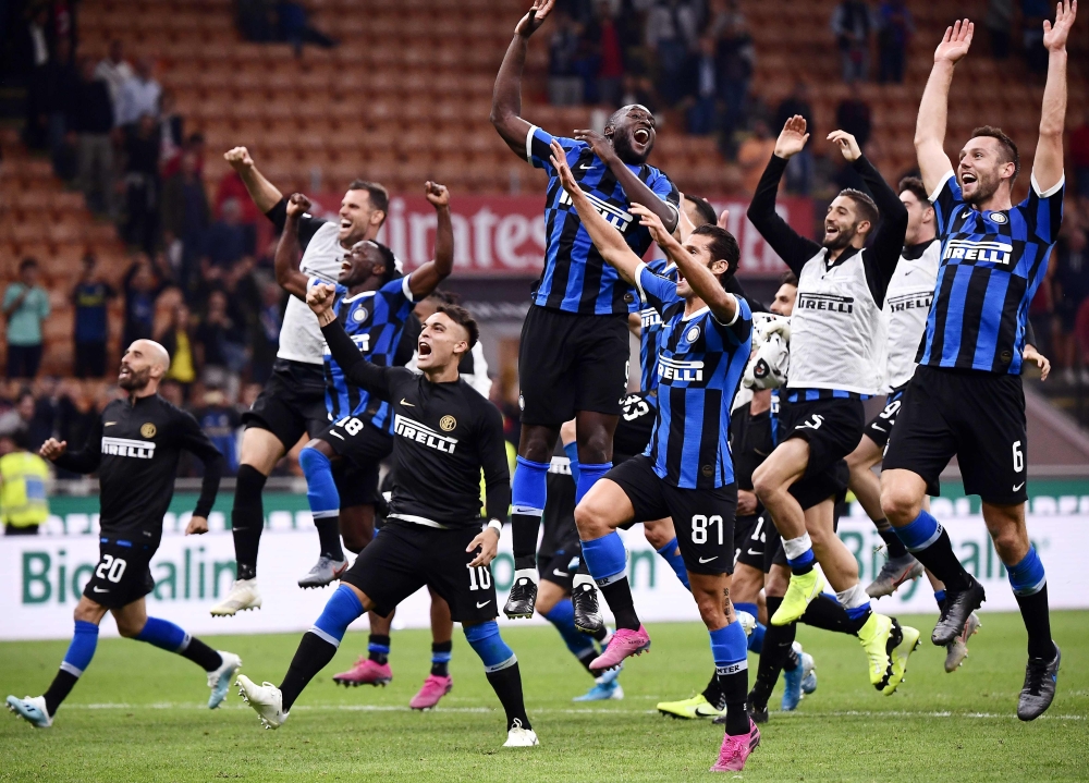 Inter Milan's Belgian forward Romelu Lukaku (Top C), Inter Milan's Argentinian forward Lautaro Martinez (4thL), Inter Milan's Italian forward Antonio Candreva (FrontR), Inter Milan's Dutch defender Stefan de Vrij (R) and teammates acknowledge the public a