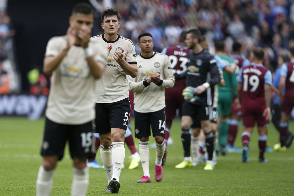 Manchester United's English defender Harry Maguire gestures at the final whistle during the English Premier League football match between West Ham United and Manchester United at The London Stadium, in east London on September 22, 2019.   AFP / Ian KINGTO