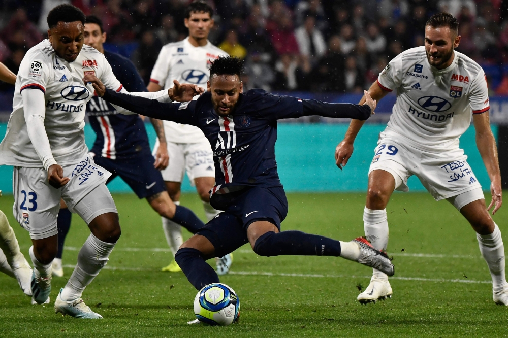 Paris Saint-Germain's Brazilian forward Neymar kicks shoots to score a goal during the French L1 football match between Olympique Lyonnais (OL) and Paris Saint-Germain (PSG) at the Groupama stadium on September 22, 2019 in Decines-Charpieu, near Lyon. / A